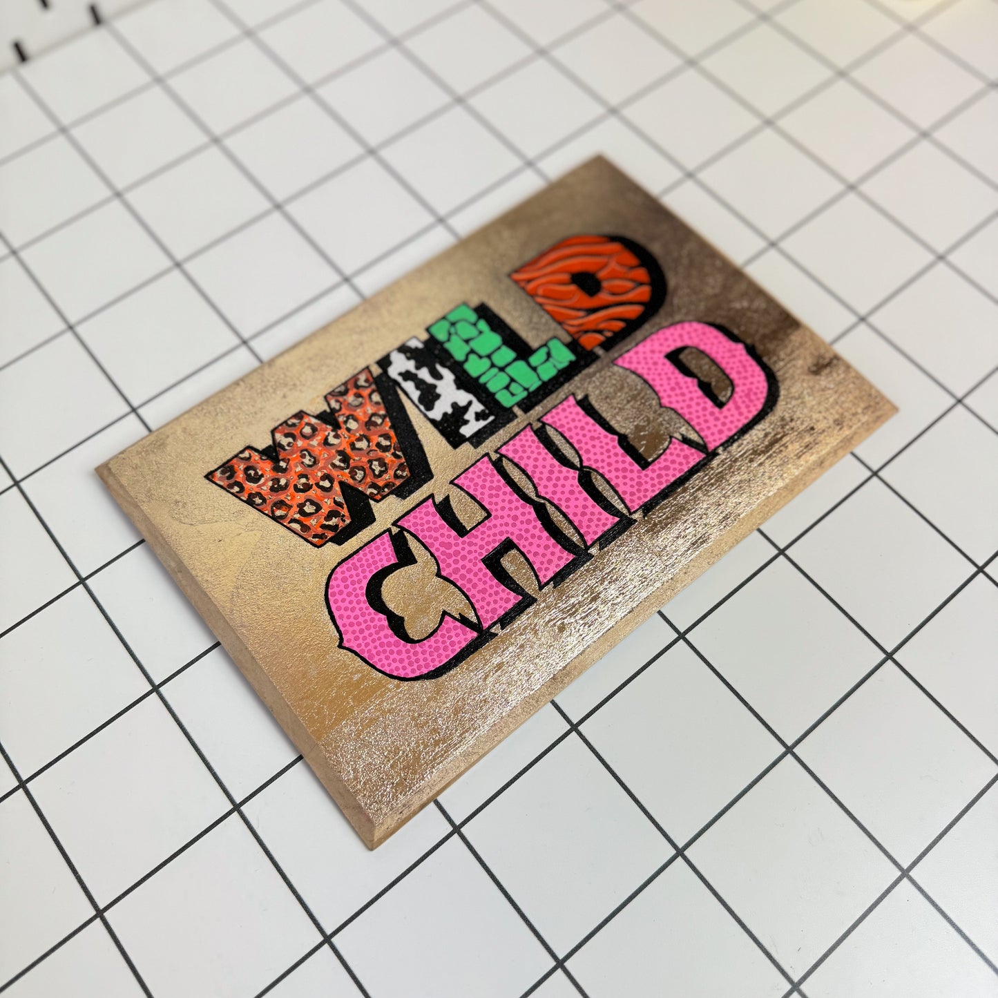 Alternative view of Stoofy's original Wild Child signwriting artwork with gold leaf and bold acrylic lettering on a white background hand-painted and gloss finished . This is a limited edition, one of one maximalist, contemporary artwork by UK artist, Stoofy.