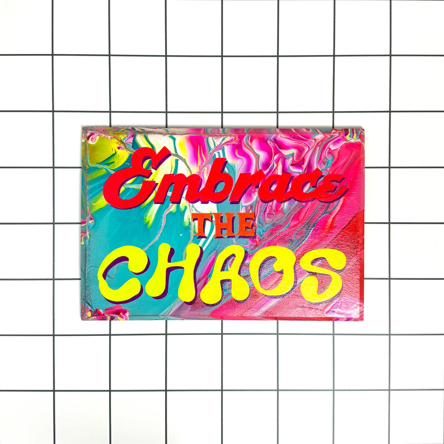 Main view of Stoofy's colourful, hand-painted sign that reads “Embrace the Chaos,” designed in a vibrant, maximalist style with glossy varnish. A unique gift or statement piece for bold interiors. Limited edition, one of one, contemporary artwork. Human-made by artist, Stoofy.