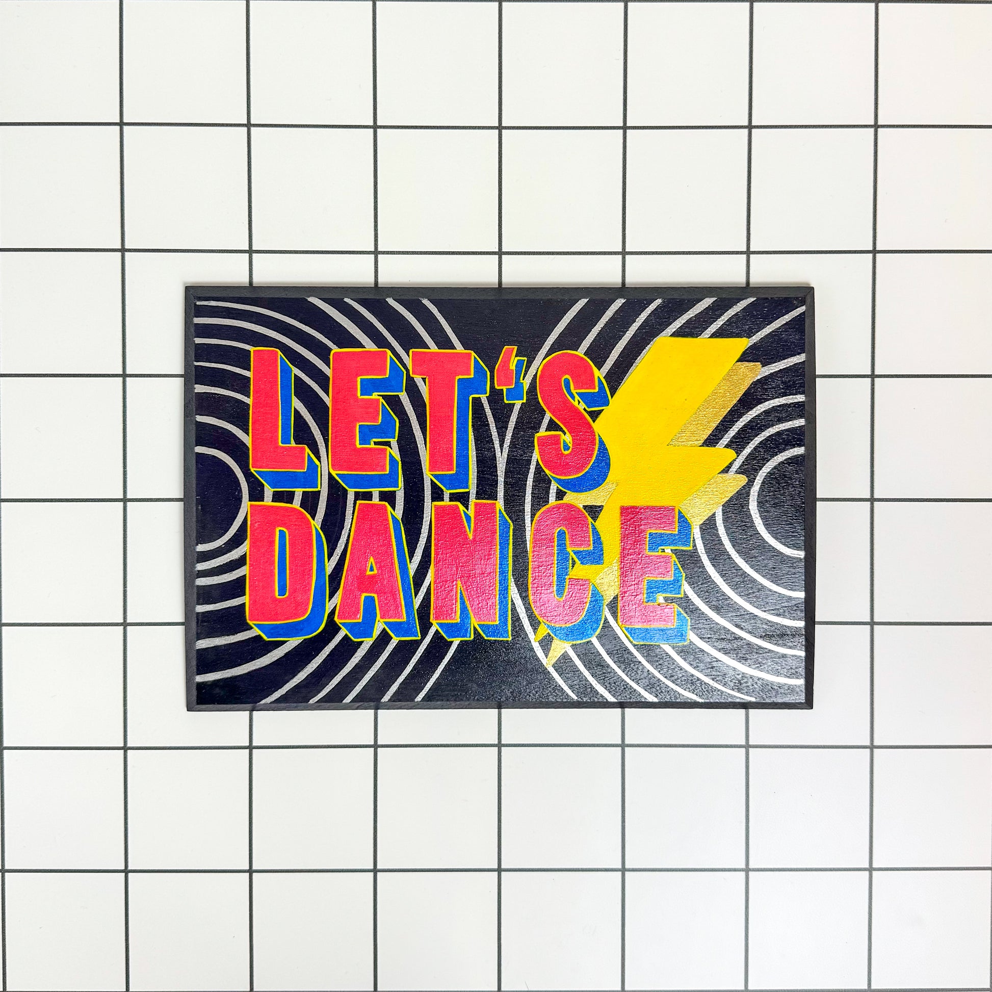 Stoofy's Bowie music inspired, ‘Let’s Dance’ hand-painted sign featuring vibrant colours and expressive lettering on a textured and metallic background by artist, Stoofy. Original, one of a kind art collectible.