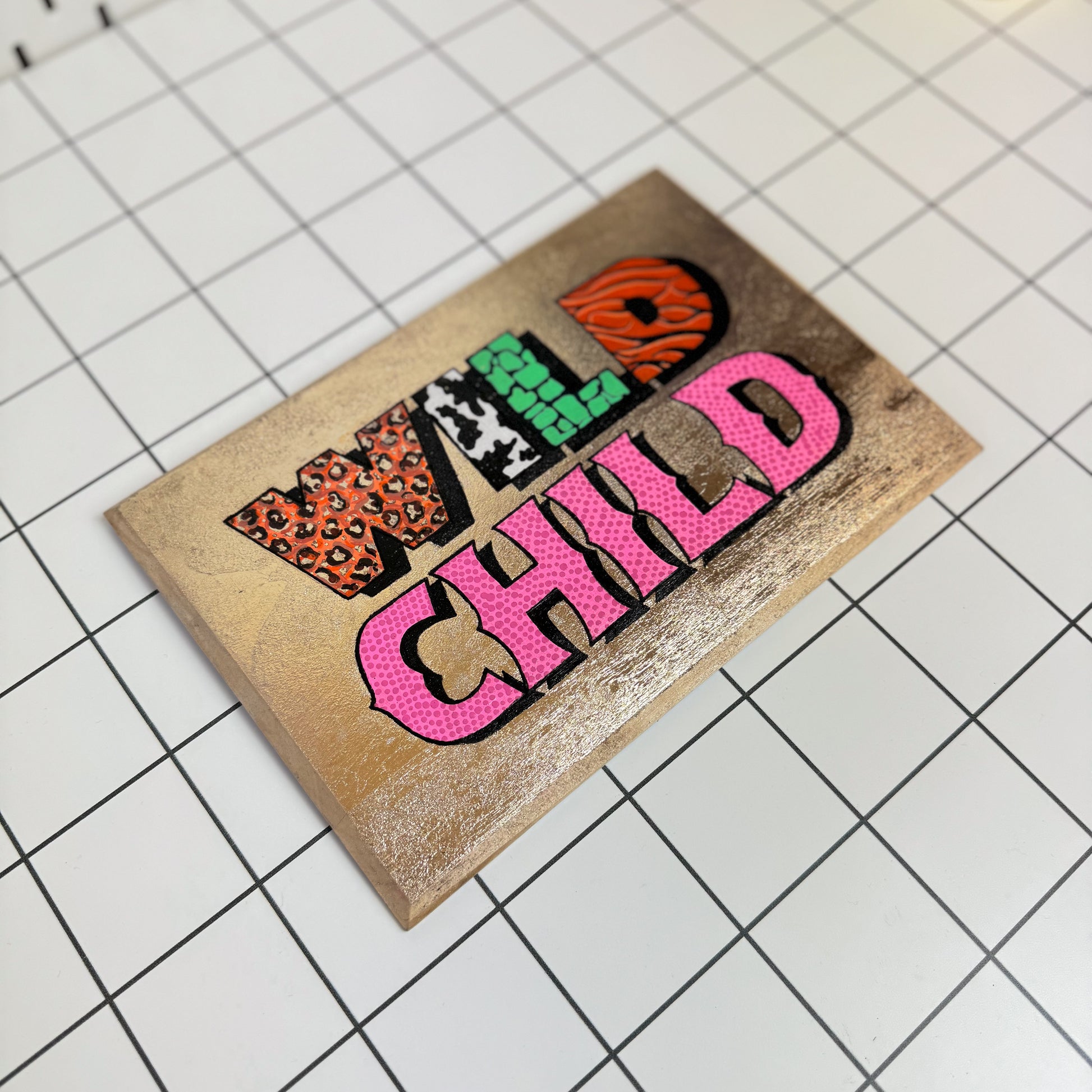 Alternative view of Stoofy's original Wild Child signwriting artwork with gold leaf and bold acrylic lettering on a white background hand-painted and gloss finished . This is a limited edition, one of one maximalist, contemporary artwork by UK artist, Stoofy. 