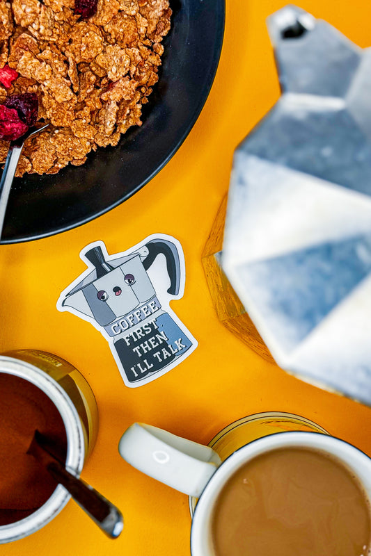 For coffee lovers and stickerheads - Stoofy's Coffee First, Then I'll Talk die cut vinyl sticker, styled with breakfast paraphernalia. Design and copyright owned by UK artist, Stoofy.