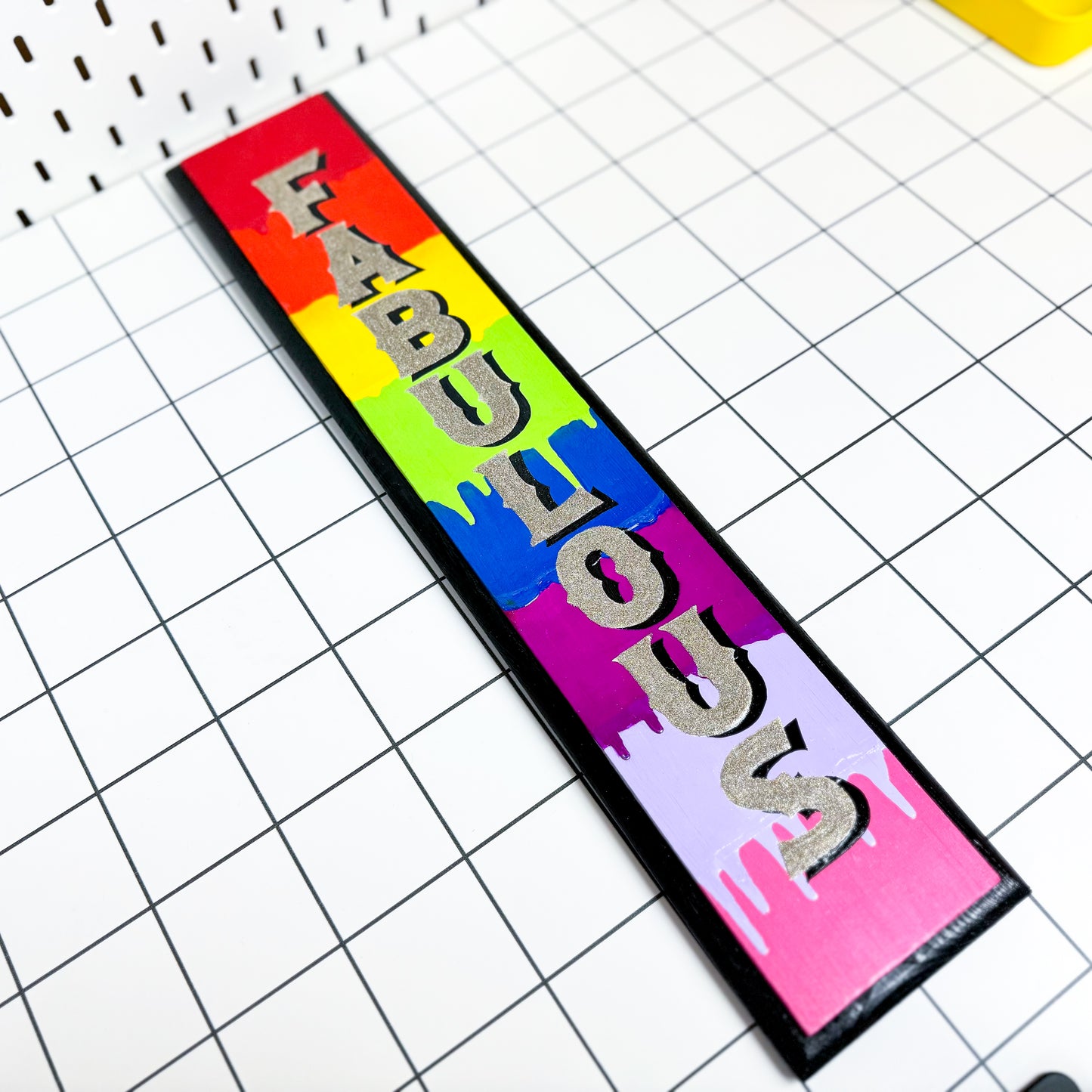 The Stoofy Store “Fabulous” is a striking, vertical hand-painted sign adorned with a rainbow of bright, dripping colours and glittering lettering. It's a bold statement piece that celebrates individuality and joy.