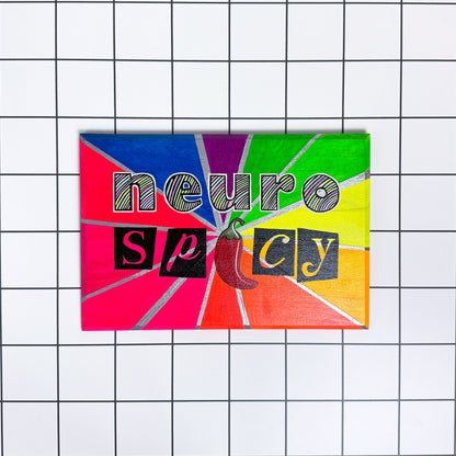 Neuro Spicy sign with pastel lettering and silver accents on a rainbow spectrum background, hand-painted with a glossy finish.