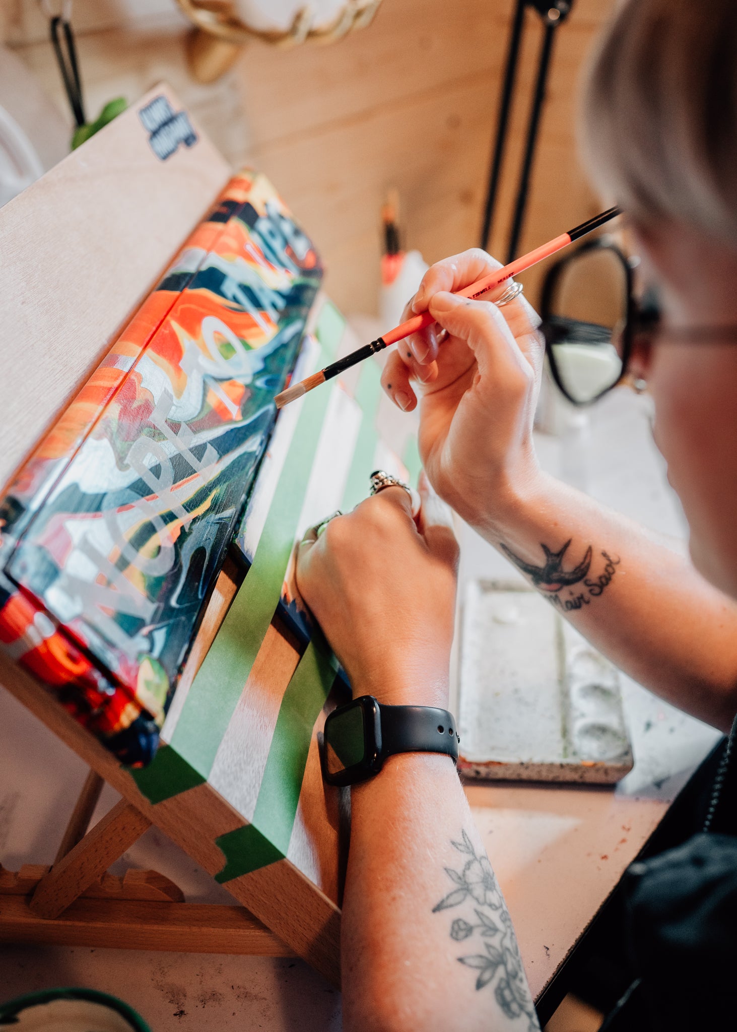 UK artist Stoofy signwriting in her UK Studio. Photography by Claire Roads Photography 