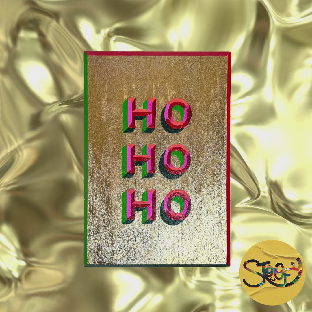 Hand-painted “HO HO HO” Christmas sign with red glitter and bold festive colours.