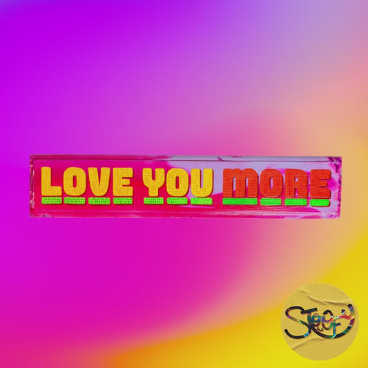 Hand-painted “Love You More” sign with bold lettering and vibrant colours on wood by The Stoofy Store
