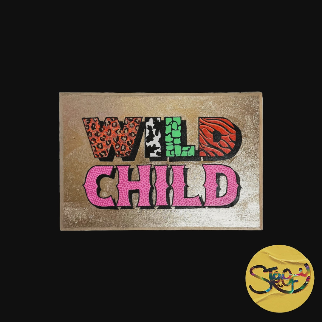 The Stoofy Store Wild Child sign with gold metal leaf and bold lettering on a black background, hand-painted and gloss finished.